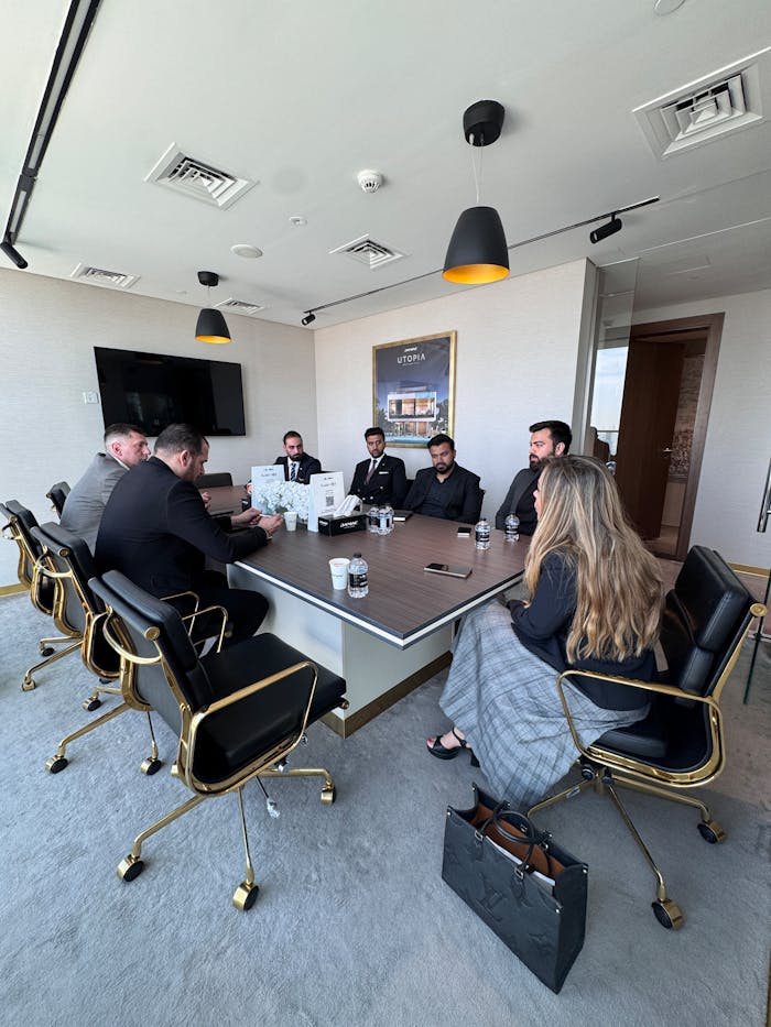 Corporate executives engaged in a meeting in a stylish conference room with modern decor.